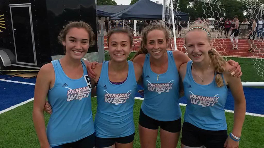 Sophomore+Chloe+Hershenow%2C+junior+Emily+Dickson%2C+and+sophomores+Natalie+Butler+and+Tess+Allgeyer+celebrate+after+finishing+first+in+the+4x800+meter+relay+at+sectionals+on+May+22.+