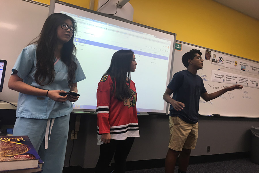 Junior Cheryl Ma and sophomore Gokul Venkatachalam performs a presentation with senior Brooke Ryan.