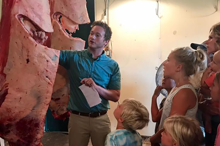 Jordy Berger explaining beef carcass evaluation at the Porter County Fair where he served as the official judge for beef, pork and lamb carcass classes in Porter County, Indiana in July 2017.