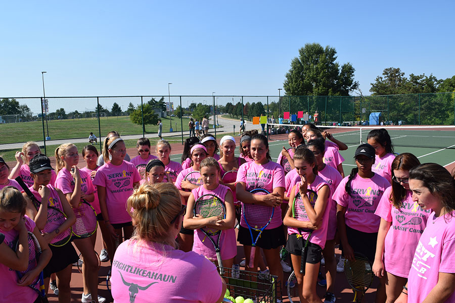 Wearing+t-shirts+in+support+for+Brynn%2C+the+tennis+team+huddles+together+before+their+match+on+Sept.+8.