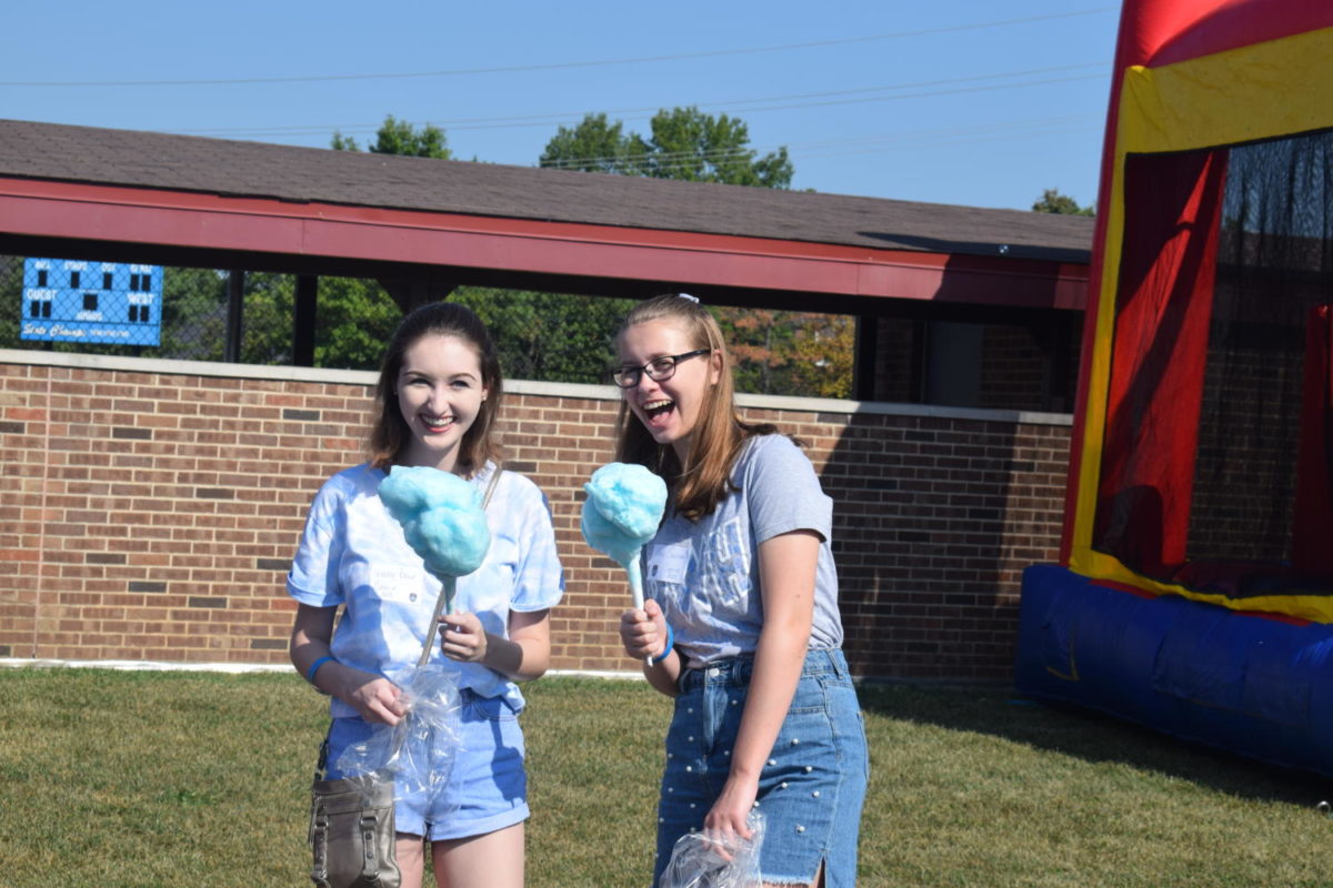 Carnival-goers pose with cotton candy.