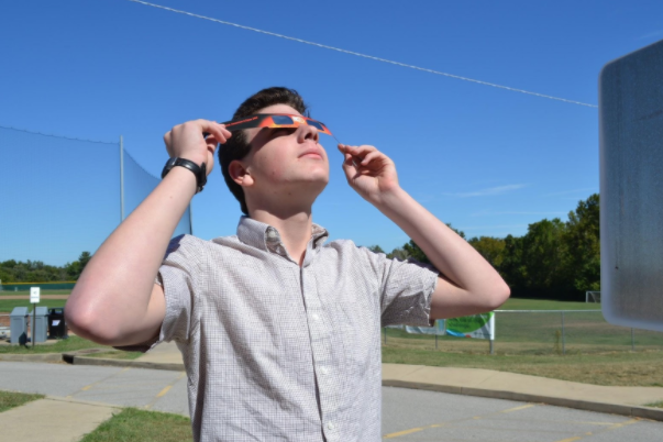 Wilken uses glasses from the solar eclipse to observe the sun. He spent the entire day of the eclipse teaching science classes what he’s learned about the sun and letting students look through a solar filtered telescope at the sun.