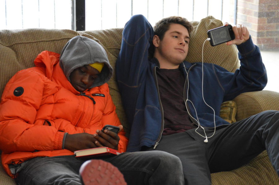Playing on their phones instead of doing homework, seniors Terrell Jones and Jonathan Dixon relax in the senior lounge. The senior lounge was given to seniors as an alternative to the study hall rooms, but Dixon used it as a place to watch Netflix. “The moment I stepped into West High this year I knew I wanted to get out as soon as possible,” Dixon said. 