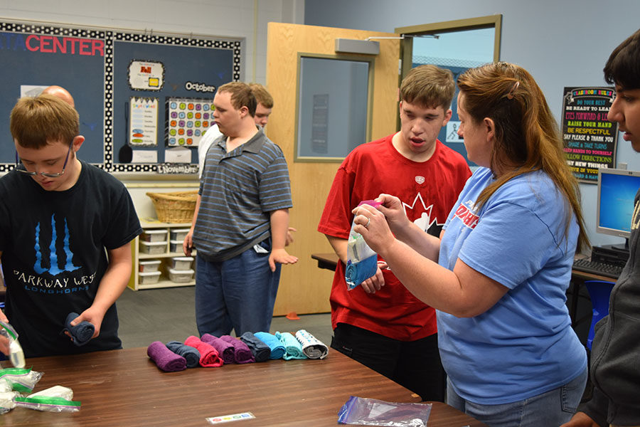 Special School District teacher Therese Meres helps senior Nick Waldrop package a hygiene kit. Over 100 shoe boxes were filled by West students. [Operation Christmas Child] packs 20,500 shoeboxes with fun toys, school supplies and hygiene items for children affected by war, disease, disaster, poverty and famine, Operation Christmas Child of St. Louis’ media coordinator Julie Northrip said.