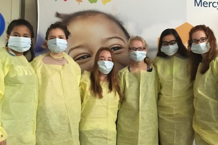 Dressed in face masks, gloves and isolation gowns, students pose for a picture for their Health Careers Field Day field trip. Attendees were able to meet and talk with health professionals of varying occupations in the medical field. “I wanted to go because I want to be a doctor, and being able to submerge myself into this kind of environment and get an even better idea on my future career seemed fun and beneficial to me,” sophomore Mckenna Bendle said.