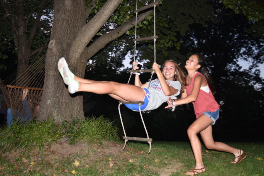 At senior captain Betsy Waits team dinner, junior Gabby Leon pushes junior Chloe Hershenow on a tree swing. 