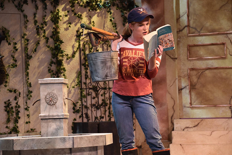 Reading a book to the audience, Kathryn Harter leads a scene in “The Three Musketeers” as Sabine in June 2017.