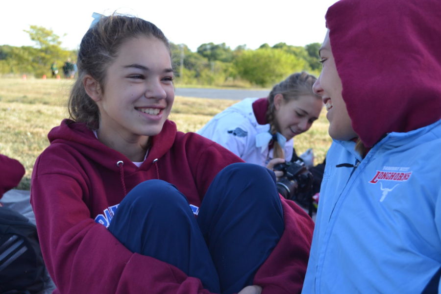 While talking about race strategy before their race, Freshmen Makenna Dunn and Emma Smout bundle up. West placed first in the varsity and freshmen races and JV placed second at the West Invite.