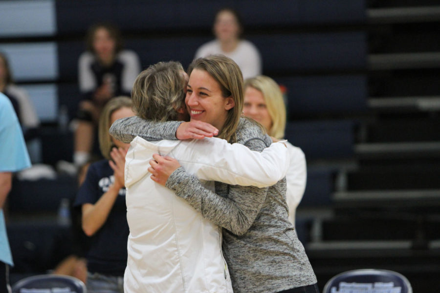 Susan Dean hugs her 23-year-old daughter Molly Dean before the volleyball game against Webster Groves during the 2016-2017 season. The match ended in a victory for the Longhorns in two games, 25-18 and 27-25. “The game was really special, in my mind that speaks for the tradition and longevity of our program,” Dean said. 