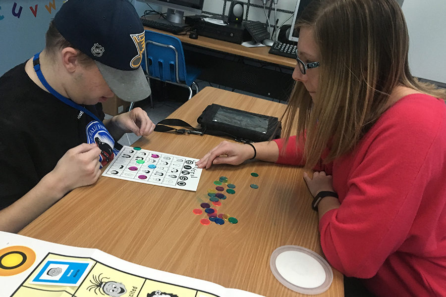 Special Education teacher Nicole Sneed helps senior Nicholas Waldrop at a game of bingo. “My favorite thing about my job is the relationship I have with my students. I enjoy having inside jokes with my students as well as knowing their interests. It helps us connect and form a positive relationship, Sneed said.