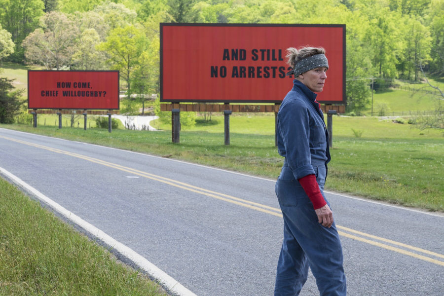 Mildred Hayes stands in front of two of her billboards alongside a road outside Ebbing, Missouri. 