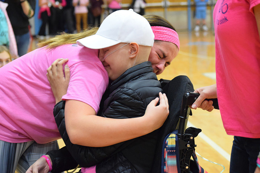 Receiving her honorary high school diploma with sophomore Kelly Wehrmeister by her side,  sophomore Brynn Haun smiles into an emotion-filled hug. The school held a pink-out night in Hauns honor, while students also participated in a Hamilton-themed flash mob. Brynn meant the world to me. She made me a better person, she made me stronger even before she started with the cancer and chemo. She made me see a positive side to everything, Wehrmeister said. When she passed, she took a part of me with her. Knowing that she was such a huge part of my life makes me sad, but also makes me really happy to have had someone whos had that kind of special impact on my life.