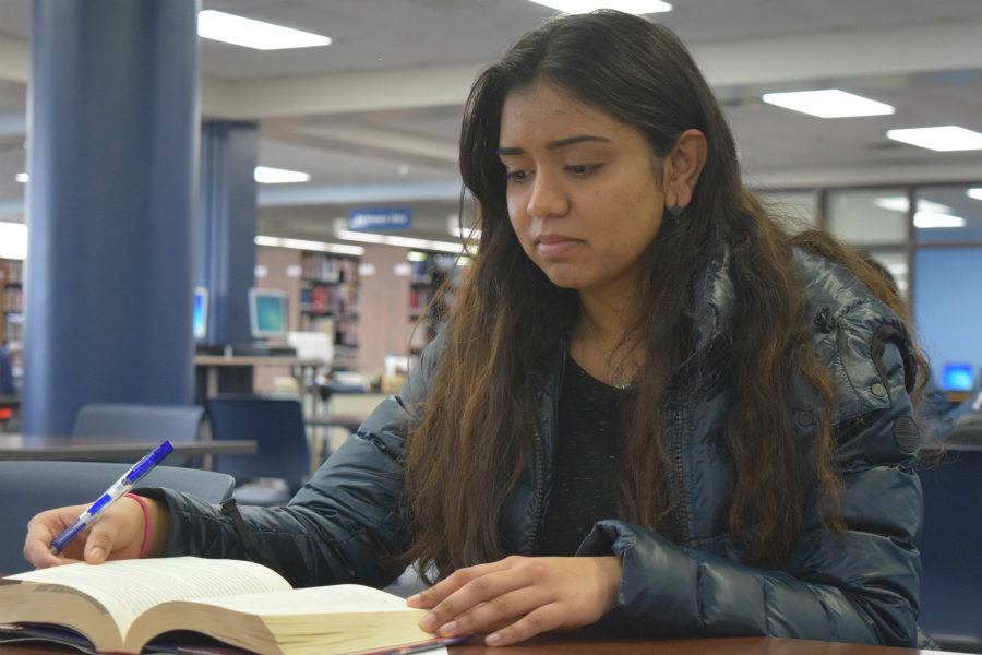 Senior Salmoi Inje works on homework in the library. “I’m in debate and mock trial so I’m not really a sports person. My interests are very much academic. I want to go into Pediatrics so I’ll probably go through some pre-med track and then figure out my special later,” Inje said. 