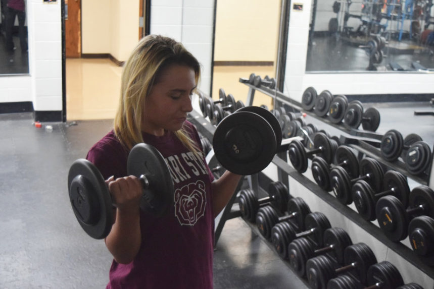 As part of her workout routine, senior Maddi Grant lifts 15-pound dumbbells. Grant started weightlifting to build more muscle and challenge herself. “I learned from a personal trainer that you should not focus on just one muscle group a day, otherwise other parts of your body get weaker. I do ab exercises, arms and legs on a day to day basis just to change it up,” Grant said. 