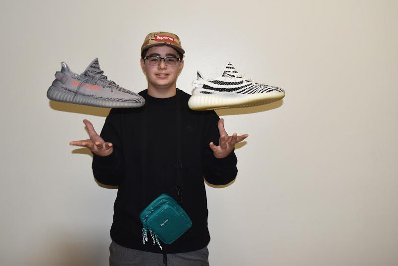 Tossing up Adidas Yeezy Boost’s, sophomore Ismail Hacking shows two pairs of shoes that are currently sold out in the retail marketplace. “My favorite thing to talk about is shoes, I know so much about them and I love to tell other people,” Hacking said.