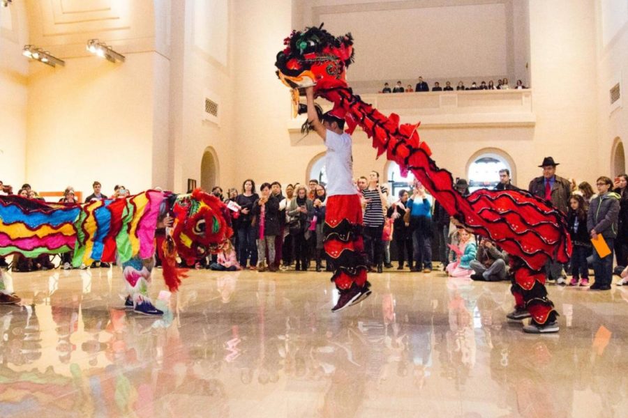 Junior Stephen Zhao performs the Lion Dance with his team as many people at the event gather to watch.  “Performing gives me a rush like no other,” Zhao said. “There are so many variables and so many new things that we do each year for the Lion Dance. We work our best to make it a great performance so that people will remember the Chinese culture.”