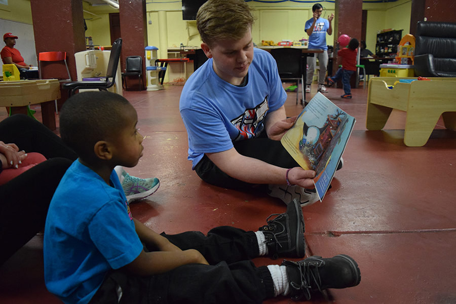 Reading to a little boy at Gateway 180, junior Tommy Harper participates in West’s first Day of Service. Gateway 180 is a homeless service for women, children and families, that provides food and clothes to those in need. “I would definitely recommend volunteering with programs like Gateway 180 because it was really cool. When we got there they showed us a video about some of the people who had lived with them for awhile and it was amazing, the little kids were so nice and energetic,” Harper said. 
