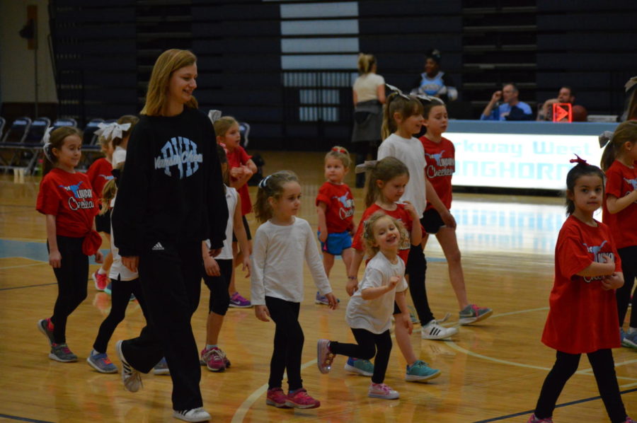 Working alongside students ranging from preschool to middle school, sophomore and varsity cheerleader Teya Everts helps the younger girls learn a dance. The Kiddie Camp was created to get students excited and prepared for high school cheer. “I love the girls so much, probably because I’m still a kid myself. I love connecting with them and getting them excited for a sport that I love,” Everts said. 