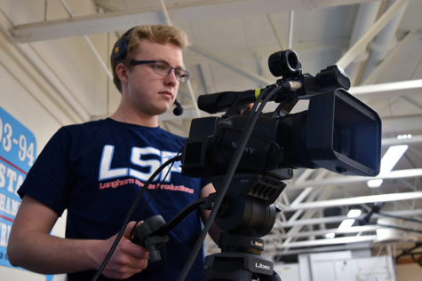 Senior Chris Narishkin live-streams basketball game. Games can last up to four hours at a time. “As a camera man, it is my job to never miss the action during this time period,” Narishkin said.