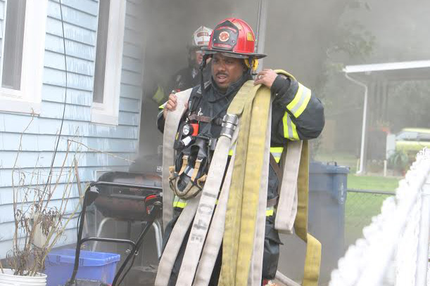 Derrick Richardson carries a fire hose in preparation to attack a house fire. He has been a firefighter for 21 years and a Fire Captain for nine of those years. “I hold a number of fire certifications and am able to do a multiple jobs in the fire service, Richardson said. “I love helping people and giving back and I do that in the fire service and in my community as a volunteer. I love the job and the work it includes.”