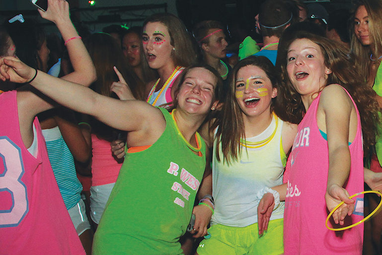 Seniors+Jessica+Schlueter%2C+Sam+Walkoff+and+Maggie+Newberry+dance+and+enjoy+the+glow+dance+that+was+held+last+year.+%E2%80%9CI+think+glow+dance+is+more+fun+because+it%E2%80%99s+not+a+formal%2C%E2%80%9D+Newberry+said.+%E2%80%9CAround+this+time+in+the+year+I+don%E2%80%99t+want+to+go+to+another+formal+because+we+already+have+so+many%2C+especially+with+prom+for+the+upperclassmen%2C+and+it%E2%80%99s+a+great+opportunity+to+let+loose.%E2%80%9D