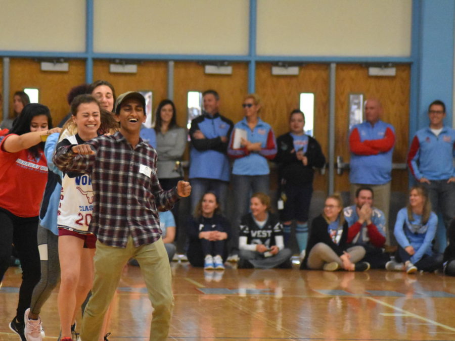 Representing the girls’ track and field team, senior Emily Dickson leads a conga line with Lafayette junior Bharat Sreekrishnavilas. “Apparently Bharat didn’t know what a conga line was, so he walked in like an elf. I knew [running in] was going to be crazy since there’s about 100 people on the team,” Dickson said. 
