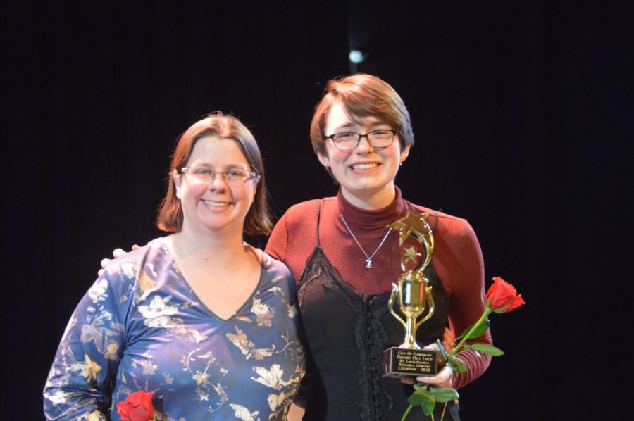 Senior Ann Truka and English teacher Andria Benmuvhar pose with roses and the Regional Poetry Out Loud Champion trophy. Truka has competed in Poetry Out Loud for four years in a row. “I was thrilled that Ann first won the school competition because she had won previously as a freshman. It felt like a nice bookend experience. The regional competition was very tight—everyone gave incredibly strong performances—so when Ann won I was very excited and proud of her,” Benmuvhar said. 