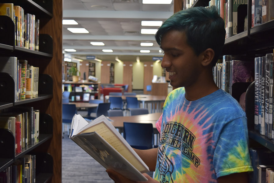 Reading a book, senior Haran Kumar studies in the library. Kumar plans to get his bachelor’s degree in Computer Science and become a professor after high school. “I think what makes Haran unique is that he combines superior intelligence with a laid-back personality and good sense of humor,” Computer Science teacher Jason Townsend said about Kumar. 

