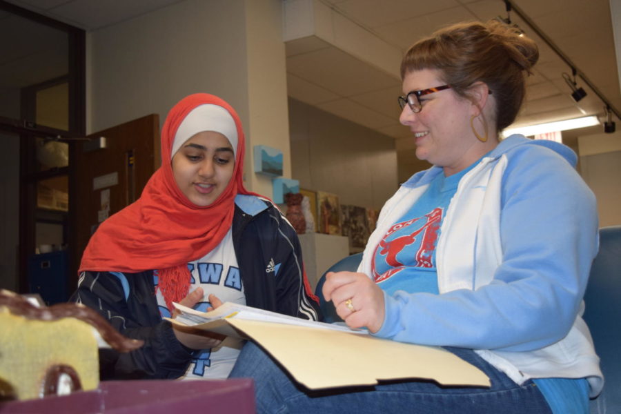 Sophomore Namah Al Battah and art teacher Ashley Drissel look over meeting plans for the club We Dine Together. The club was created to ensure all students feel included in places like the cafeteria or classroom. “We’re trying to create a network of support,” Drissel said. “[We want] to have a culture here at West High that is supportive and inclusive instead of exclusive.”