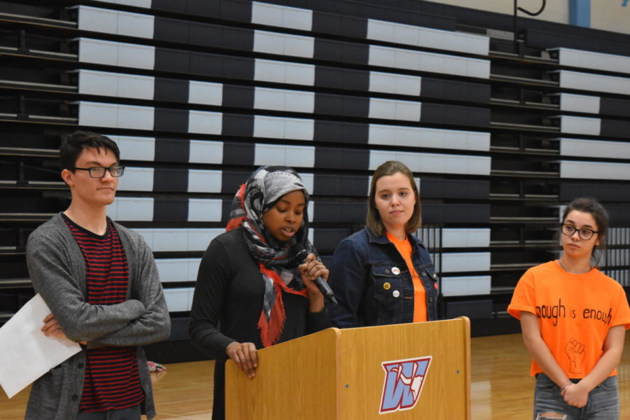 Junior Maryam Oyebamiji gives a speech on ending gun violence in schools during the March 14 walkout. Junior Tim Mcauliffe and seniors Sydney Kinzy and Kalyn Deutsch also spoke at the assembly in support of increasing gun regulation.  “I was tired of hearing about school shootings and incidents where people’s lives were lost due to gun violence,” Oyebamiji said. “I felt like just sitting around and feeling sad about what was happening around us was not enough so when I was given the opportunity to speak at the rally I took it.”