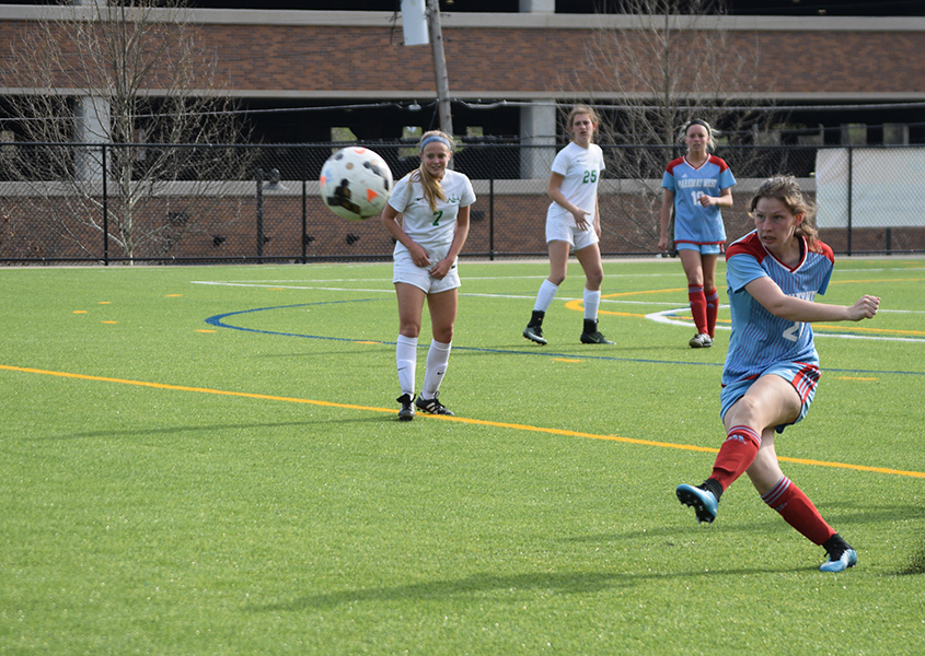 Junior Kaleigh Kastberg swings into a free kick, turf flying into the air. The varsity girls competed against Nerinx Hall on April 13. We ended up losing 2-0. We were trying to get a goal back in the last ten minutes, so we gave up a second goal, Kasper said. It went well though; I play defense, and so we were trying to shut down as many forwards as possible.
