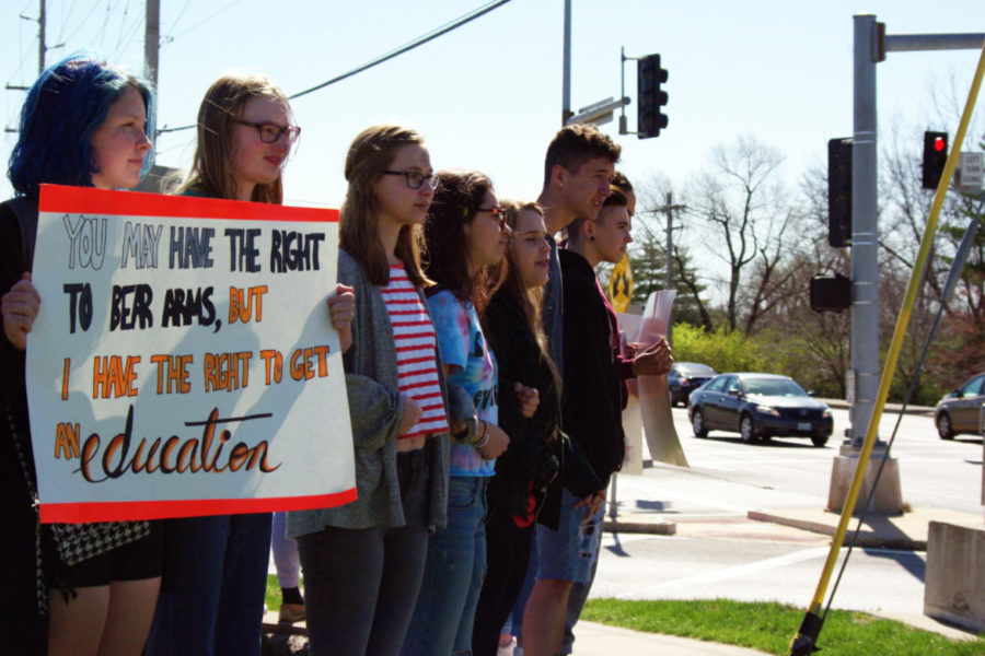 Linking arms with fellow classmates, freshman Becca Vierck holds a sign that reads, “You may have the right to bear arms, but I have the right to get an education.” On April 20, the 19th anniversary of the Columbine shooting, students staged a national walkout to demand action against gun violence. “Walking out was a crazy experience. I got to the marquee a little early and my heart was thumping out of my chest,” Vierck said. “This movement is important to me because we had a social media threat [at West], and that was right after Parkland, so I started thinking, ‘What if that was me?’”