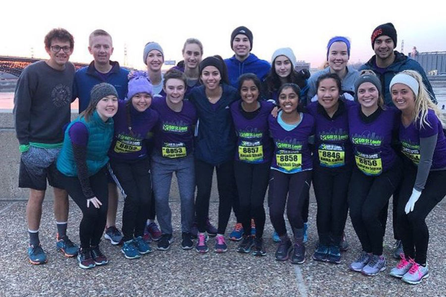 Students pose with Family and Consumer Sciences teacher Katie Hashley before running the race. Sixteen students ran the half-marathon. It was an accomplishing feeling crossing the finish line, junior Katharine Segrave said. At the last 800 meters, I was running and realized I could break two hours, so that was the most exciting feeling.