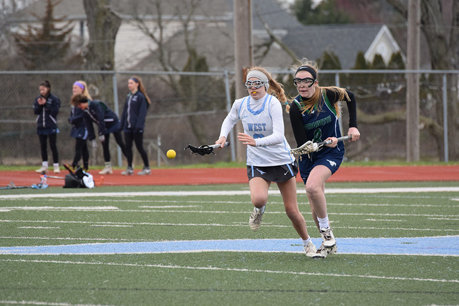 With her eye on the ball, freshman and midfielder Megan Leahy competes for the ball in a game against Marquette. This is Leahy’s first year to play competitively. “I like that the game is really fast paced, but I also really like that in lacrosse, you have to rely on other people to make everything happen,” Leahy said. 
