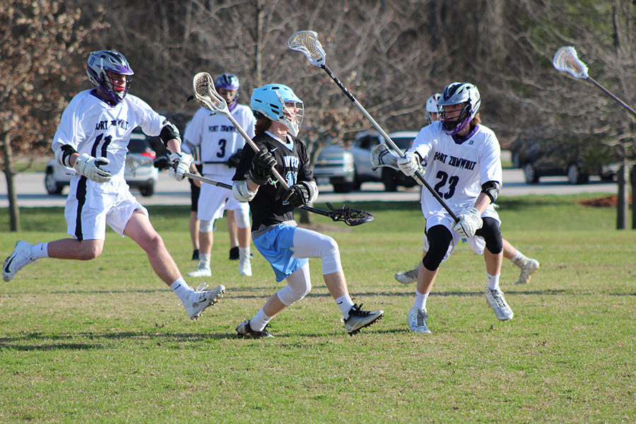 Junior+Luke+Griffith+dodges+defenders+and+passes+the+ball+during+a+varsity+lacrosse+game+April+5+against+Fort+Zumwalt+West.+West+took+the+lead+early+on+and+won+14-2.%C2%A0It+was+our+first+game+%5Bafter+spring+break%5D+so+it+was+good+to+shake+off+the+rust.+Close+to+the+end+of+the+game+I+assisted+%5Bjunior%5D+Michael+Imral%3B+it+was+his+first+goal+of+the+season%2C+I+was+proud+of+him%2C+Griffith+said.%C2%A0