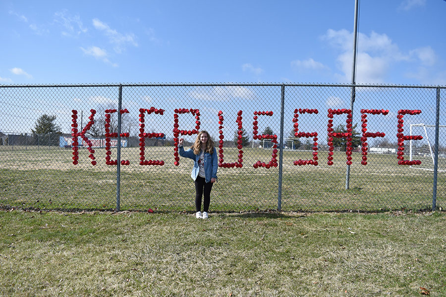 Sophomore Sabrina Bohn stands in front of the fence facing Clayton Road after decorating it with the phrase “Keep Us Safe” written in solo cups. Sophomores Lydia Harter, Carly Anderson and Emma Caplinger helped Bohn decorate the fence. “It is so important for young people to make sure their voices are heard,” Caplinger said. “The cups are to make sure that the issue is remembered past the day of the walkout, and so the community can hear our voices too.”