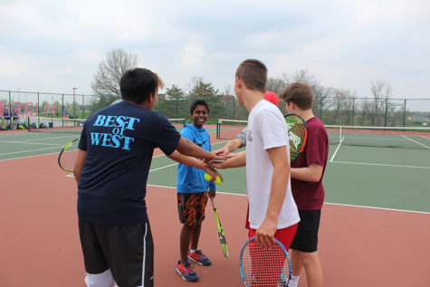 Huddling up, members of the boys tennis team prepare to practice. “On and off the court, tennis taught me how to persist, find my voice, and forge relationships,” senior and captain Chris Nariskin said. 

