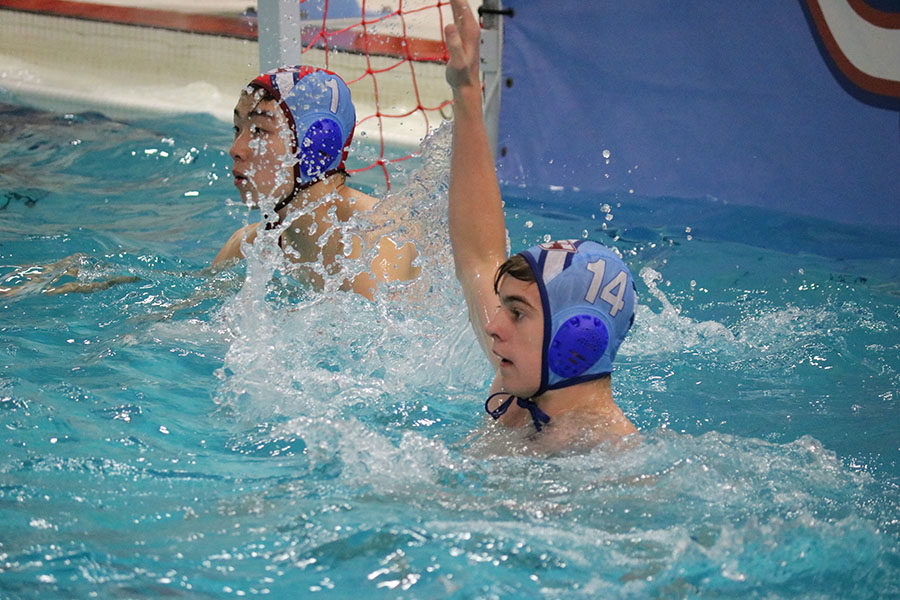 Freshman Mckay Morgan prepares for a pass during the Desmet Jesuit game on May 1. “My favorite thing about being on the varsity team is that its more challenging,” Morgan said. “Since Im just a freshman, I cant match the size of most other players in the pool. Instead, I have to really hustle and play smart to keep up with everyone else, especially since varsity play is much faster and more vigorous.”
