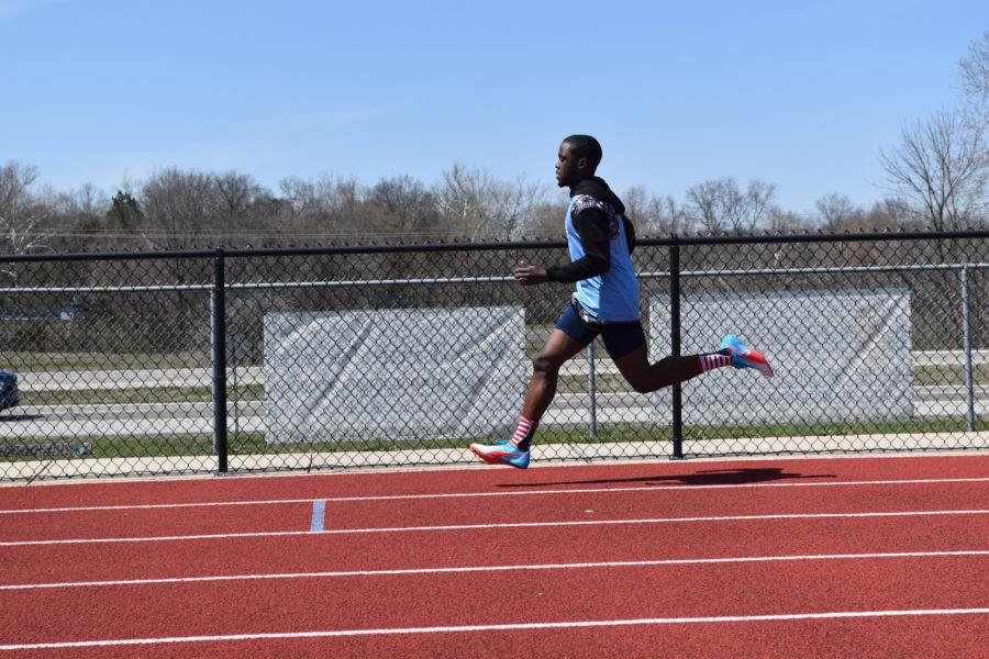 Striding out on the back stretch, senior Reggie Burns races the 400 meter dash. Burns finished fourth in the event with a time of 53.85 seconds. “I was feeling a bit under the weather so I couldn’t perform at my best, but I was able to recover by the 4x400 meter relay,” Burns said.