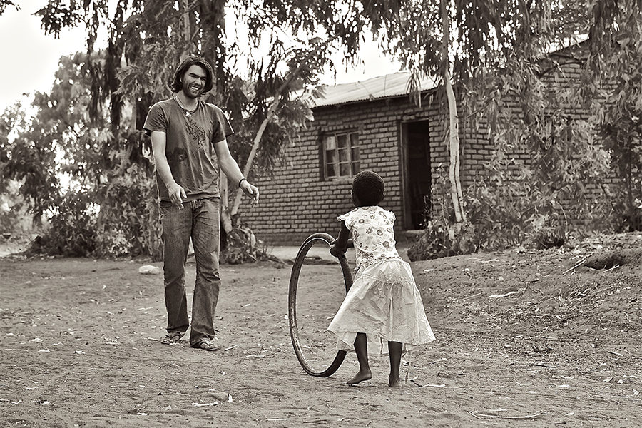 David+Peterka+rolls+a+bike+tire+back+and+forth+with+Hope+in+Malawi.+Hope+is+the+daughter+of+a+friend+of+Peterka%E2%80%99s+who+is+a+pastor+in+a+village+church.
