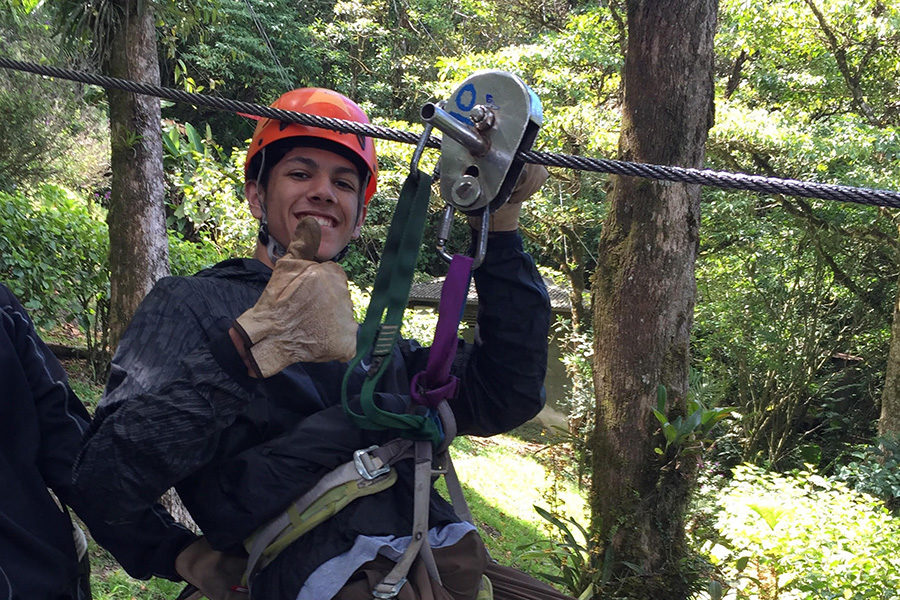 Sophomore Hasan Rizvi poses before ziplining. “It was a lot of fun hanging out with my friends outside of the country and seeing my teachers outside the classroom,” Rizvi said.