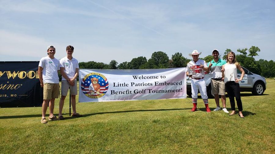 Juniors Nolan Barbre and Landon Dupont stand with volunteers at the Little Patriots Embraced (LPE) Golf Shootout. “Volunteering at events is an easy way for members of the community to get involved,” Dupont said. 