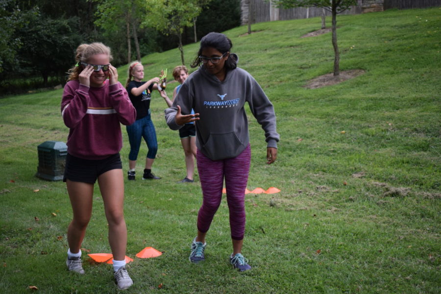 Navigating an obstacle course, sophomores and JV field hockey players Haley Keller and Rishita Nannapaneni work together to compete against their teammates in a bonding exercise. In preparation for their first game of the season Aug. 24, both the JV and Varsity teams got together for their annual Pasta Night dinner at their Head Coach Dawn Callahan’s house. “I really wanted to win because I’m really competitive, but it was hard with those eclipse glasses on,” Nannapaneni said. “I loved bonding with the team. In order to play good as a team, you have to be connected outside of the game because then you know you can rely on them to be there for you in the game and in real life.” 