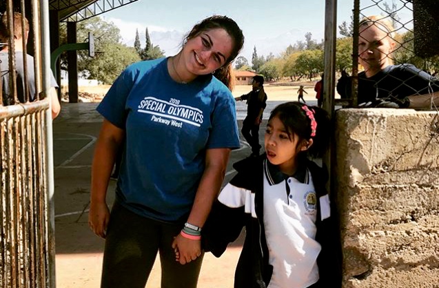 Holding hands with a student in Cochabamba, junior Kelly Wehrmeister spends her breaks dancing and playing with the local children. On the few days they had off, the group went cave spelunking and visited the tallest Christ statue in the world. “I’m the happiest when I’m serving others,” Wehrmeister said. 