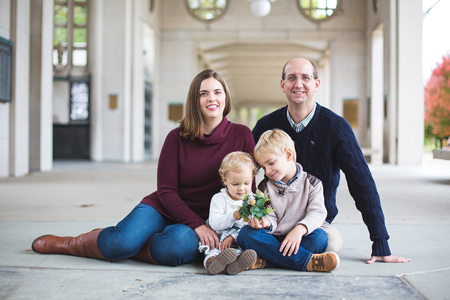 James Bosanquet sits with his wife Jill, his son Grant and his daughter Clara at the Muny entrance for a family picture. Grant and Clara are both future longhorns and Jill currently a family physician practicing weight loss medicine. “As a critical care physician, we work some long, yet predictable hours. I could not ask for a more supportive family,  Bosanquet said. My wife, Jill, is the rock of our family and keeps everything scheduled, planned and moving forward. 