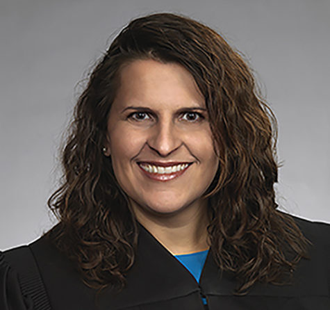 Mondonna Ghasedi poses for a headshot for her profile on St. Louis County Courts. She was able to learn how to apply rules to real-world situations at 14 years old as the only female baseball umpire at the Ballwin Athletic Association. “It took a lot of courage to make the calls on a diamond full of older male teenagers, but I quickly learned that a firm grasp of the rules and the confidence to apply them made me one of the more sought after umpires by coaches and players alike,” Ghasedi said. “It was not always easy and sometimes the answer was not clear but, with attentiveness, commitment and an understanding of the rules, I made the calls with confidence. These experiences only enhanced my commitment to justice and fairness and furthered my desire to know the rules that applied to those principles.”