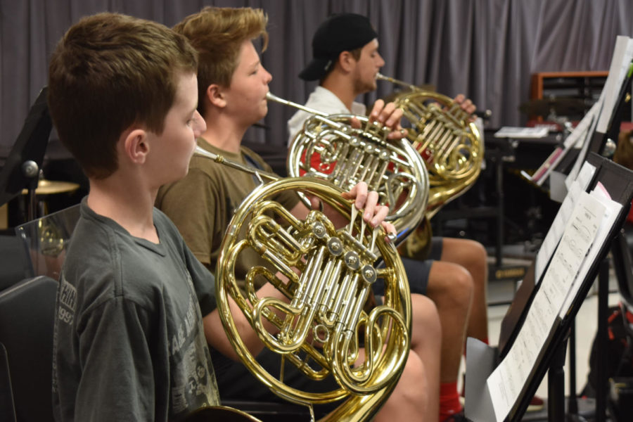 Freshman Caleb Upchurch plays the french horn in concert band. “I think band has been fun so far, and the level of music is about average,” Upchurch said. Currently in the process of selecting what to play in their October concert, the students are playing a wide variety of pieces from Robert Sheldon to Caesar Giovannini.