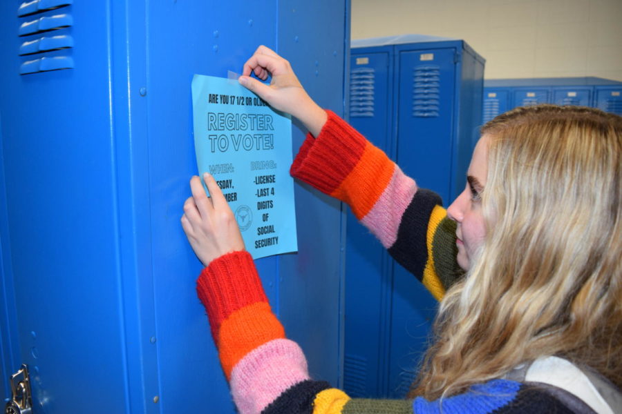 Hanging a flier on a locker, junior Sabrina Bohn raises awareness for the upcoming voter registration event Sept. 18. The campaign seeks to increase youth voter turnout ahead of the 2018 midterm elections. It may not seem like one vote can change the way things are, but it really can, Bohn said. Some candidates win by one vote in a precinct, so your vote really does matter and that’s why it’s so important for high schoolers to start registering.