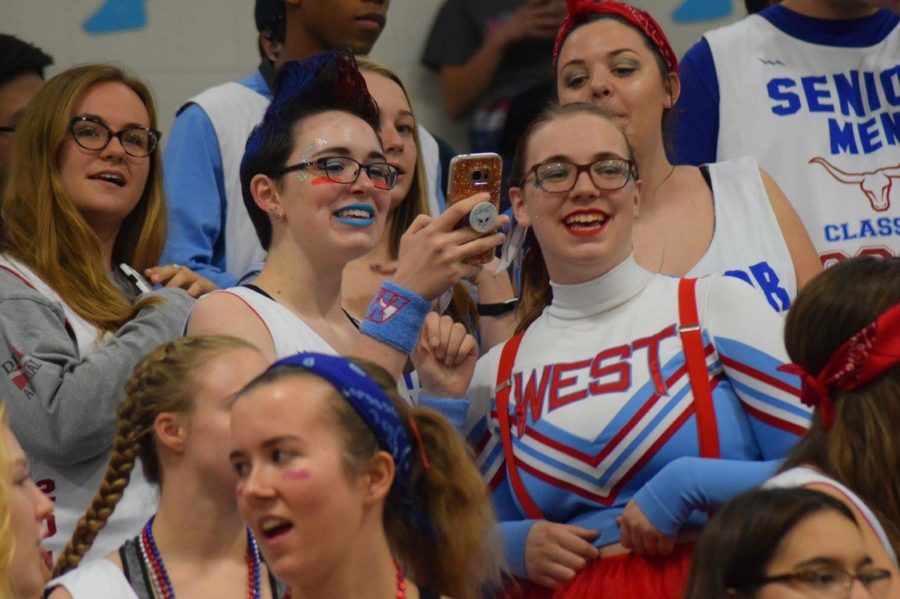 Students laugh in the bleachers at last years homecoming pep rally.