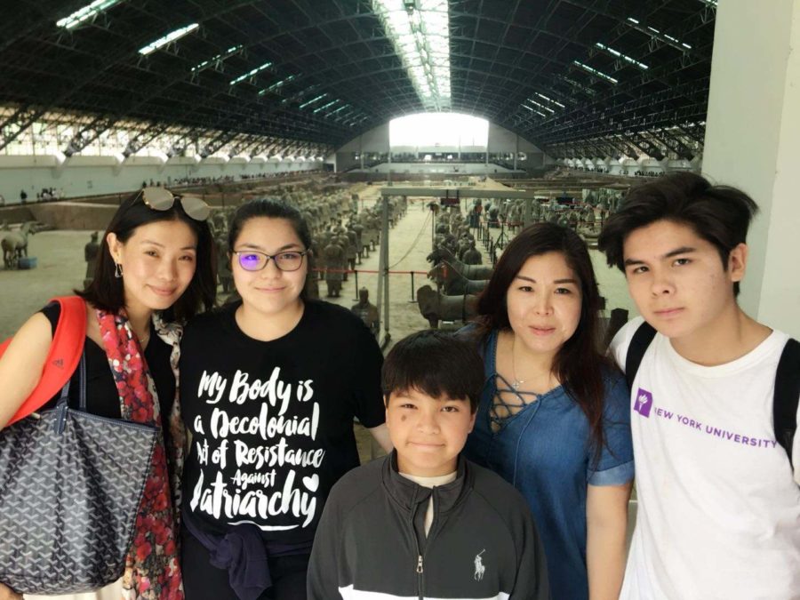 Standing with a family friend, mother Xiao Gray, brother Christopher Gray, freshman Victoria Gray and sophomore Andrew Gray visit the terracotta warriors in Xi’an China. The Gray family visited the museum after the children finished camp. “By the end [the museum]  got jam packed with people, tourists, students and guides, but luckily we got there early. It was really interesting to see all the statues in real life,” Victoria said.